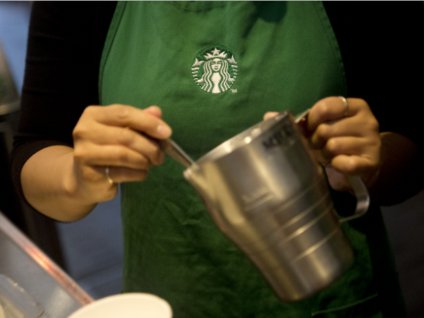 Image of a woman serving Starbucks coffee