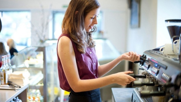 Image of a student operating a coffee maker